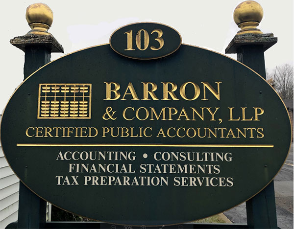 Barron and Company, LLC street sign with green background and gold lettering